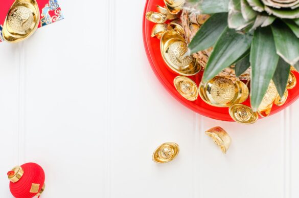 Chinese New year Pineapple with group of gold ingots in red tray